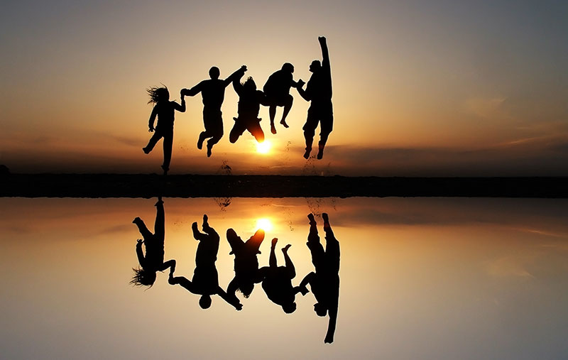 Quantum Services People People jumping in front of a sunset