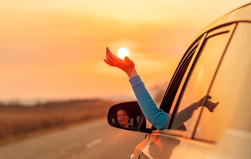 Quantum Services Jobs Woman driving with her hand out of her window